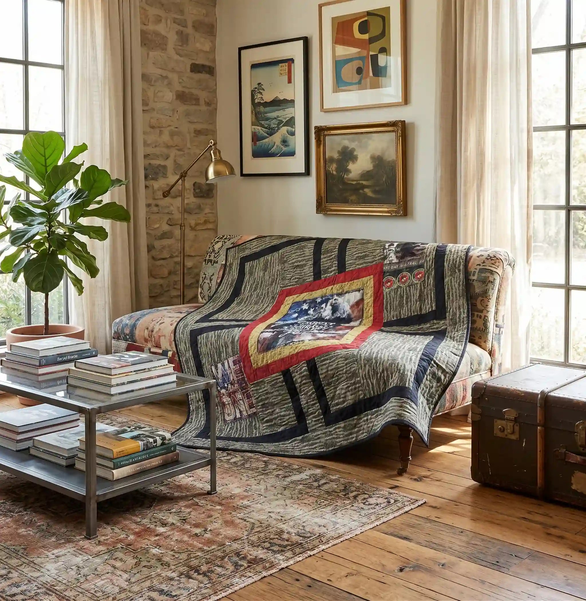 Marine Eagle Handmade Throw Quilt is draped over an armchair in a styled living room with a stone wall, windows, and a vintage trunk.