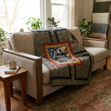 Marine Eagle Handmade Throw Quilt draped over a beige sofa in a neutral living room setting. 