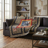 Marine Eagle Handmade Throw Quilt draped over a dark gray sofa in a living room setting. 