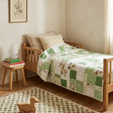 Meadow & Mischief shown on a toddler bed in a simply decorated child's room, showing the quilt can grow with the child.