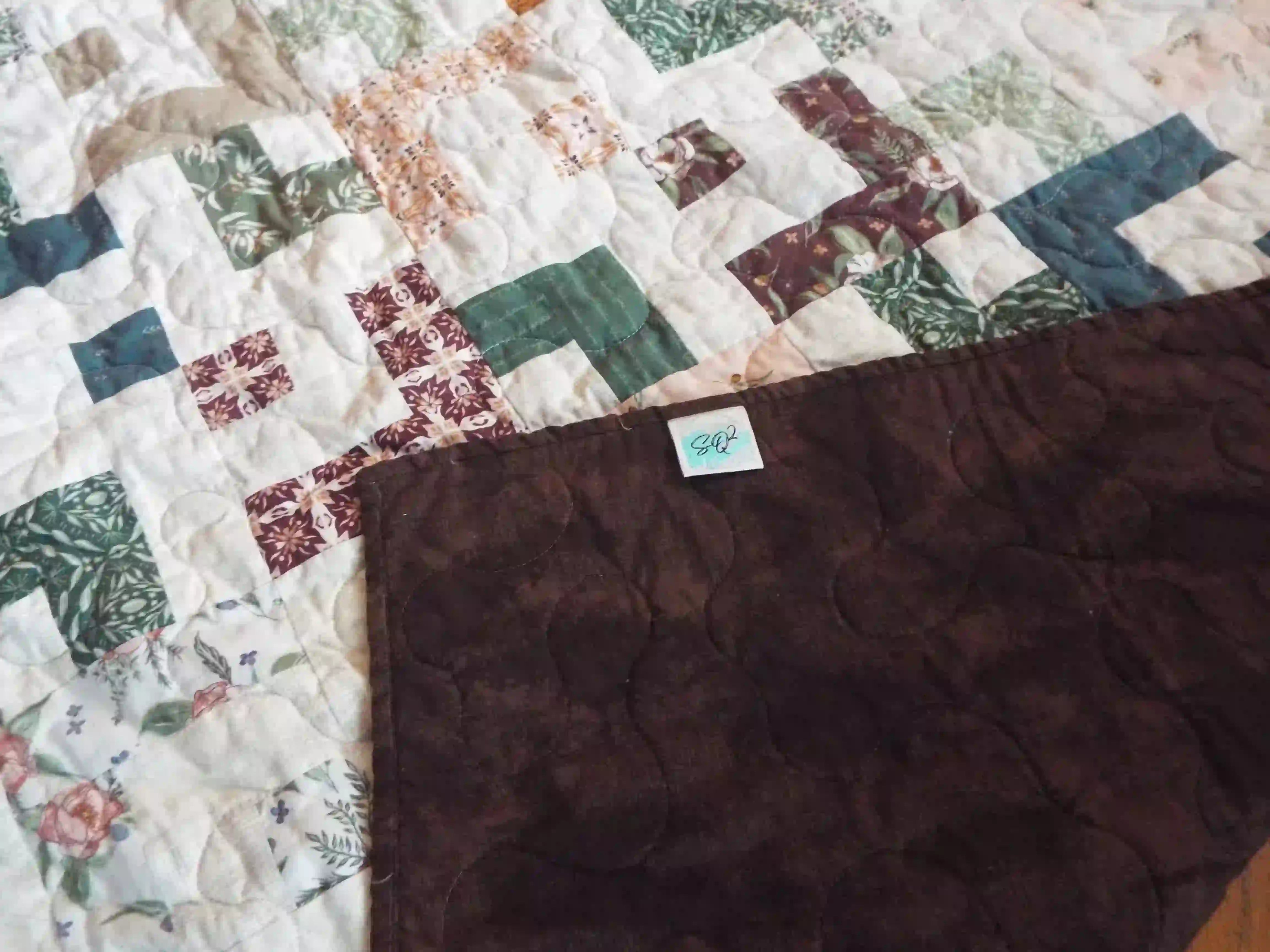 Quilt shown with corner flipped over to show backing and stitching detail