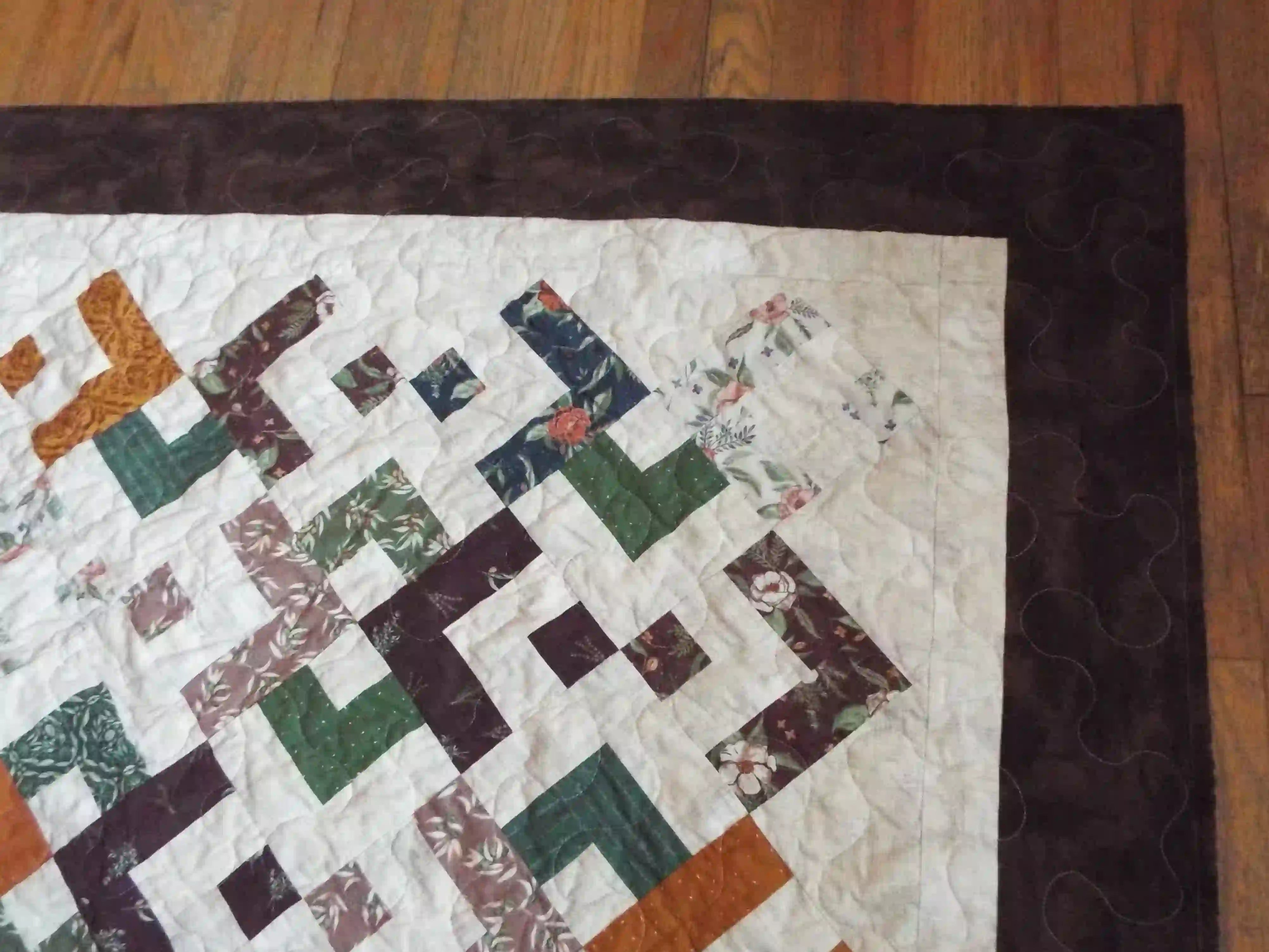 Detail shot of quilt showing border, binding, and stitching detail