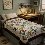 Quilt shown on a twin bed in a dorm room
