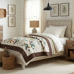 Quilt shown on a twin bed in a farmhouse styled bedroom
