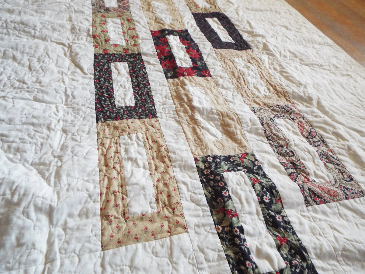 Angled flat lay of elegant minimal holiday quilt