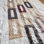 Angled flat lay of elegant minimal holiday quilt