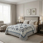 Quilt shown on bed in a traditionally styled room with architectural molding