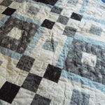 Quilt stitching detail of modern black and white handmade quilt