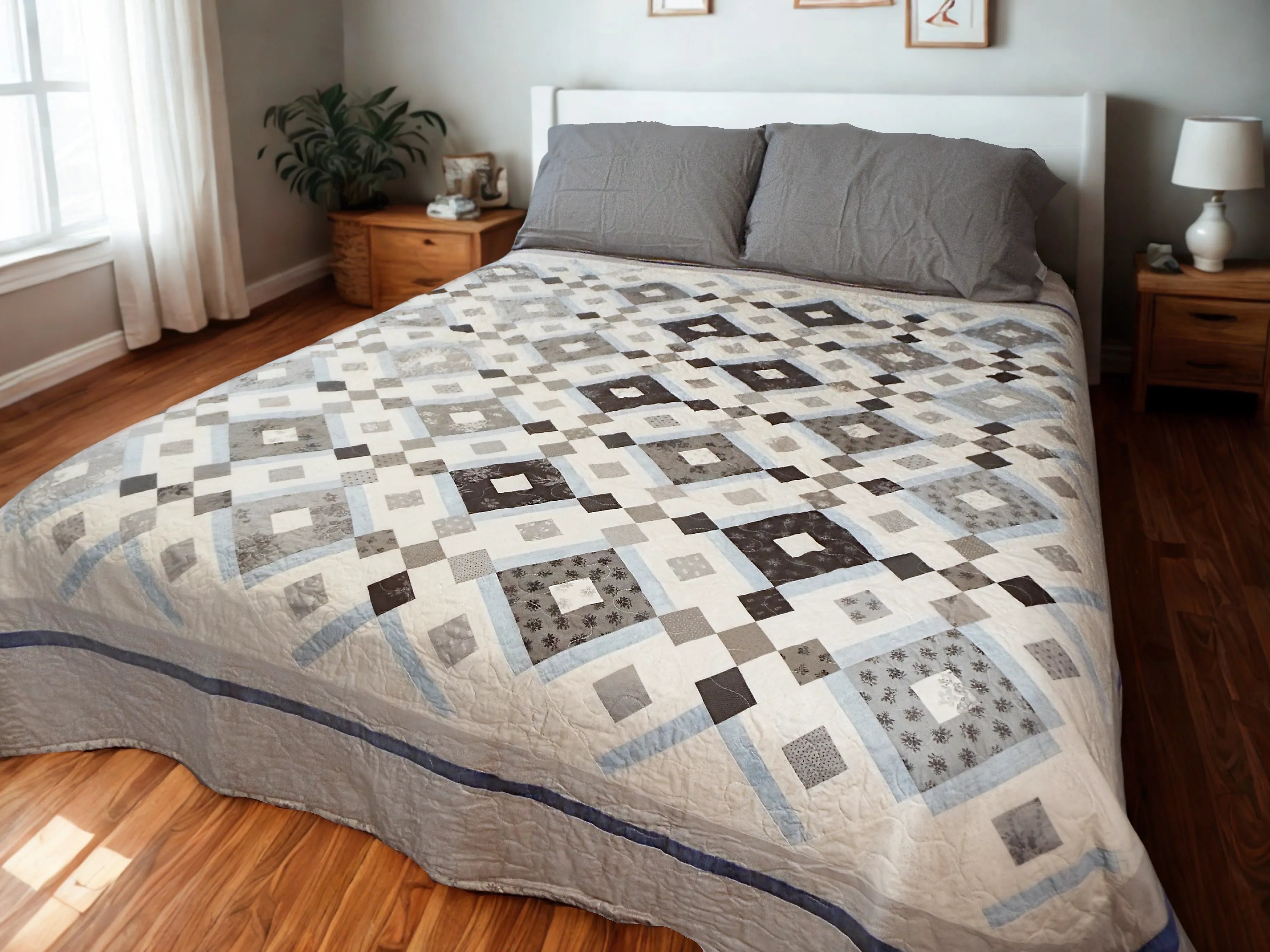 Modern black and white handmade quilt styled in a traditional minimal bedroom