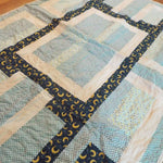 Angled lay of Moonlit Pathways Baby Quilt showing closer look at top.