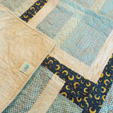 Corner flipped up on Moonlit Pathways Baby Quilt showing backing detail.