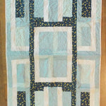 Flat lay of Moonlit Pathways Baby Quilt showing entire quilt.