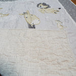 Corner of safari panel quilt showing tonal gray and white backing