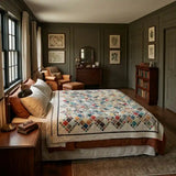 Of Ink & Thread in a masculine bedroom with dark walls and dark wood furniture.
