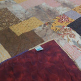 Retro-Mod Orchid King quilt showing corner flipped over to see backing and stitching detail.