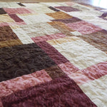 Angled shot of rose gold handmade quilt