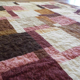 Angled shot of rose gold handmade quilt