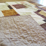 Handmade rose gold throw shown with backing flipped up to show stitching