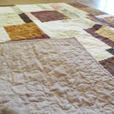 Handmade rose gold throw shown with backing flipped up to show stitching