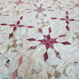 Detail shot of Scarlet Correspondence Queen Quilt showing stitching and fabrics.