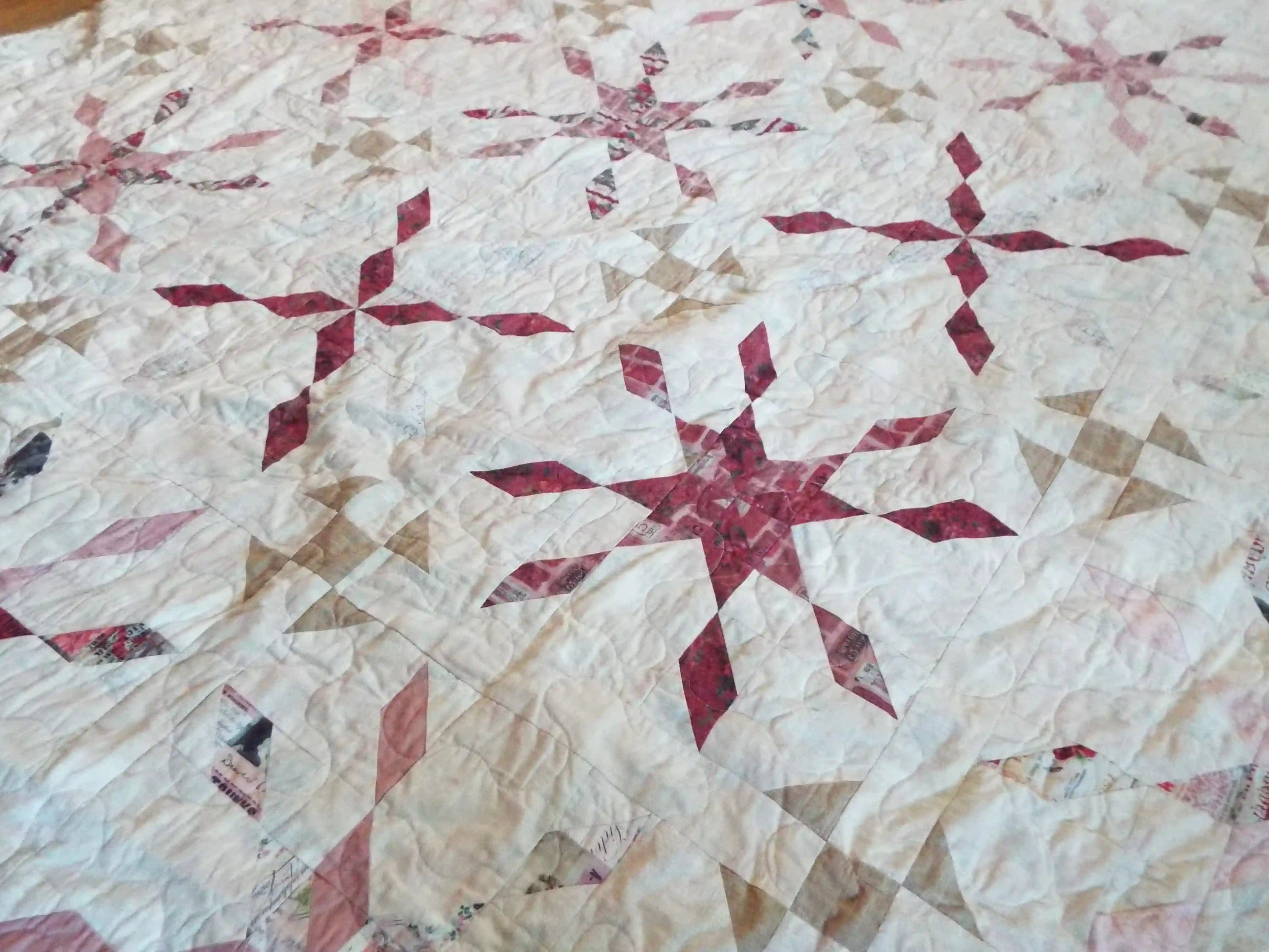 Detail shot of Scarlet Correspondence Queen Quilt showing stitching and fabrics.
