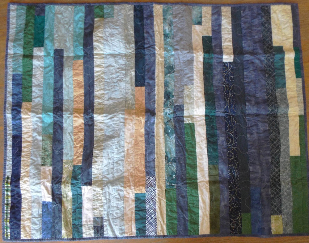 Blue striped quilt flat lay showing entire quilt