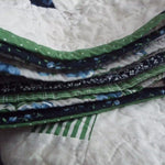 Close up of binding on the Shoreline Queen showcasing the varied fabrics used