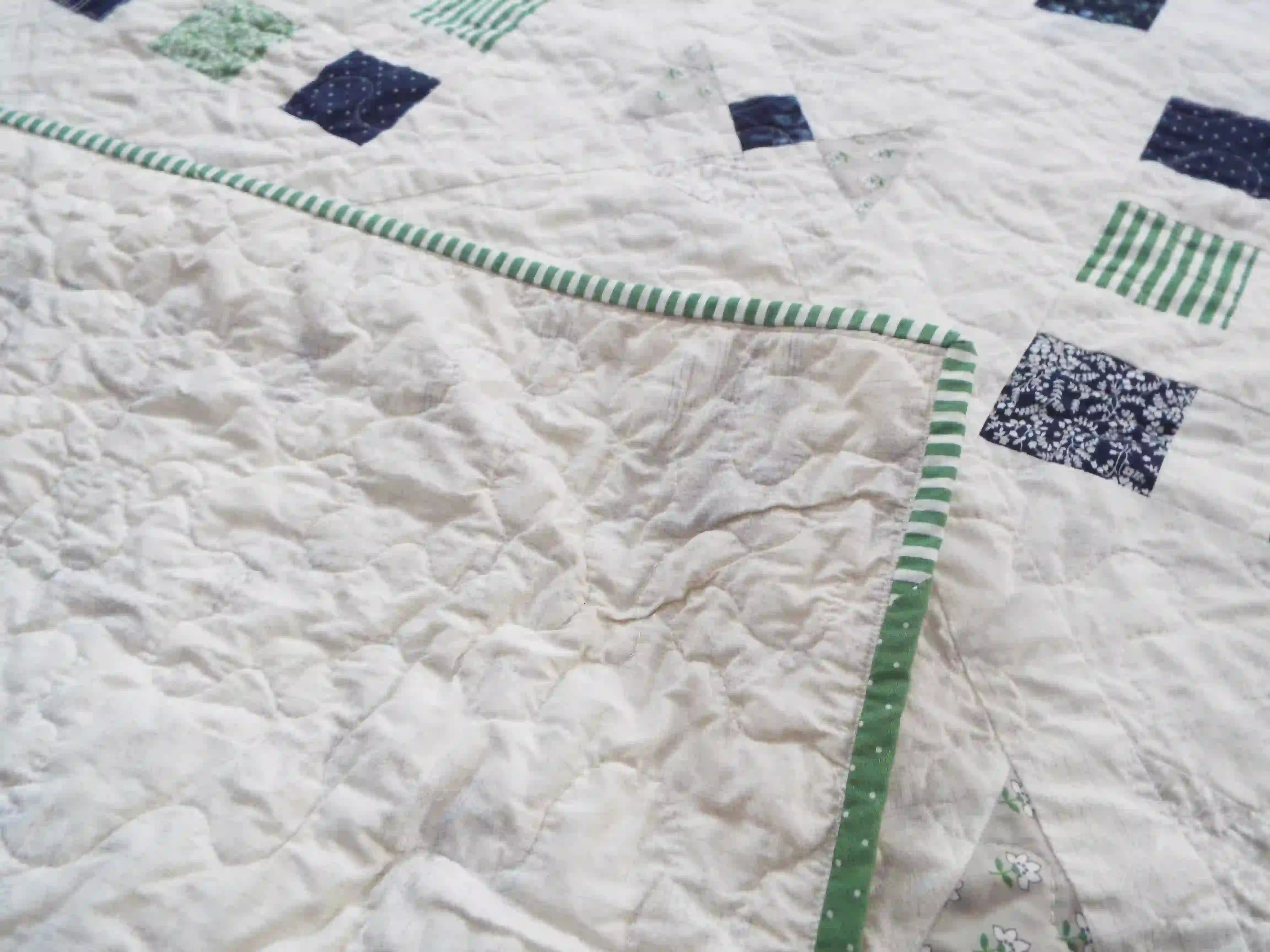 Corner flipped over to show backing on quilt top