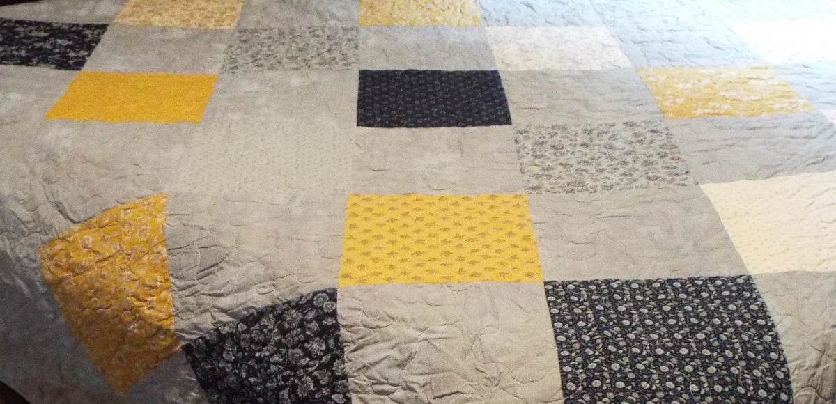 close up of handmade queen somerset blues quilt