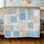 Handmade blue baby quilt draped over wooden crib in nursery with wood floors