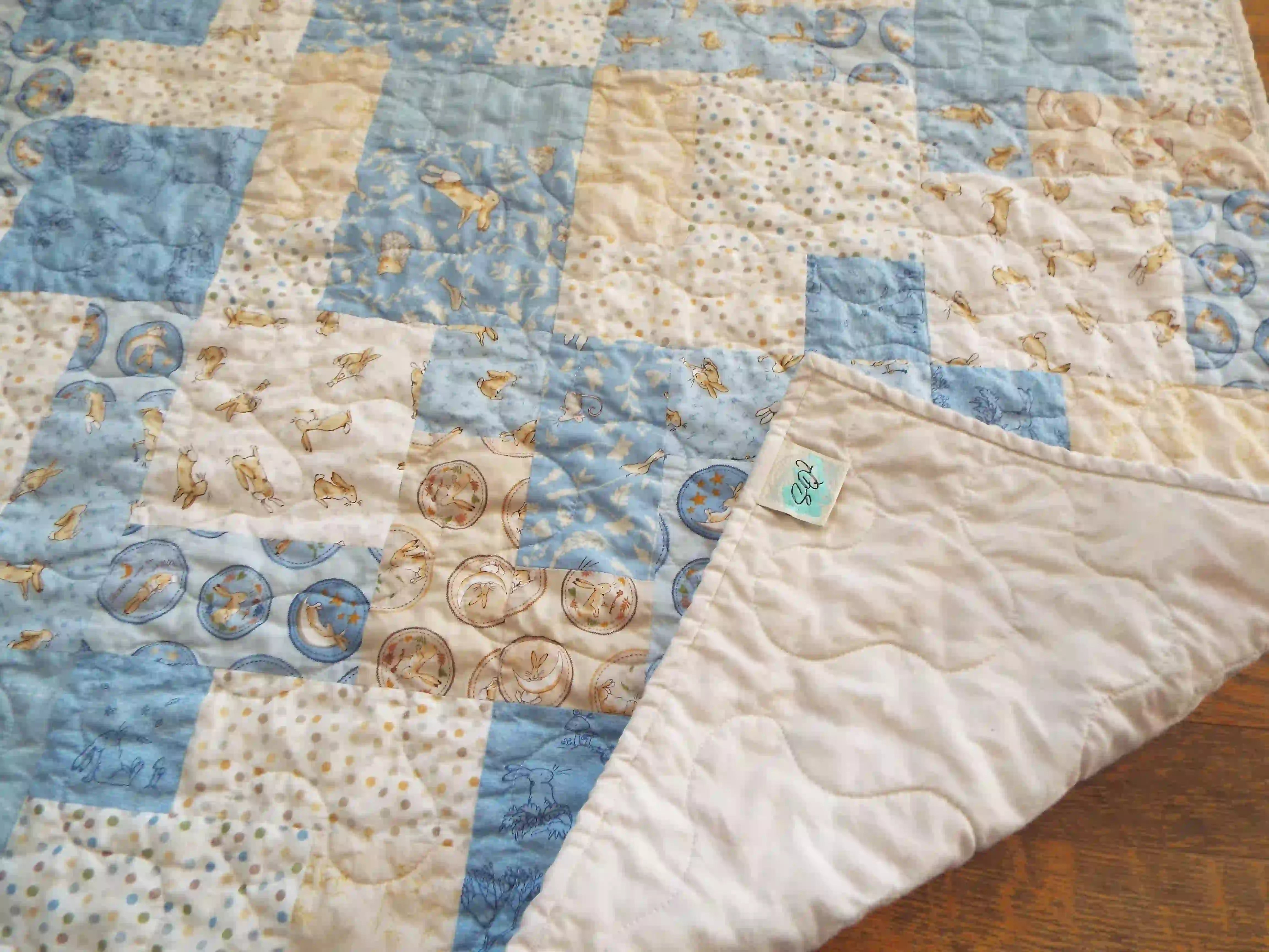 Quilt shown with corner flipped up to show the backing and stitching detail