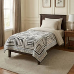Handmade twin quilt in black and white styled in a traditionally decorated bedroom