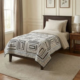 Handmade twin quilt in black and white styled in a traditionally decorated bedroom