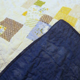 Handmade quilt with corner flipped to show backing with quilt top