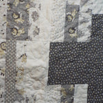 close up of stitching on Starlit Trails gray baby quilt