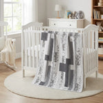 Starlit Trails draped over a white crib in nursery