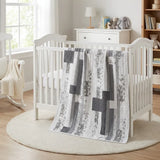Starlit Trails draped over a white crib in nursery