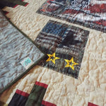 Close up of the corner flipped over to see the backing, quilt top, and label together