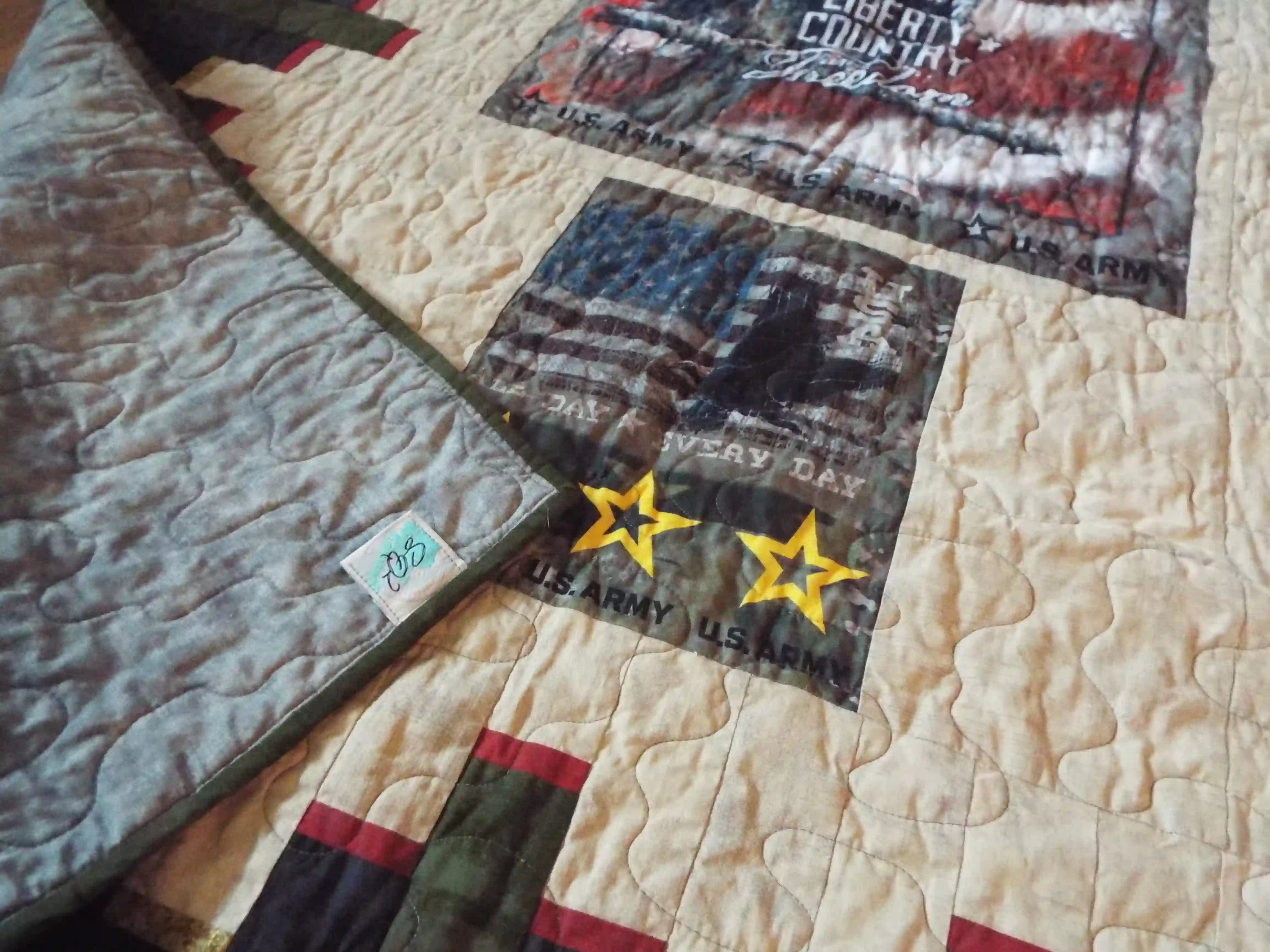 Close up of the corner flipped over to see the backing, quilt top, and label together
