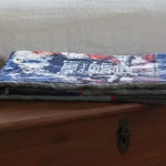 Eagle tribute quilt folded on top of wooden trunk