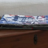 Eagle tribute quilt folded on top of wooden trunk