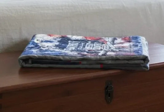 Eagle tribute quilt folded on top of wooden trunk