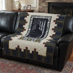 Soldier tribute quilt shown on a leather couch.