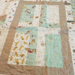 Detail of Stories in the Woods showing close up of fabric and quilt stitching.