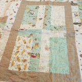 Detail of Stories in the Woods showing close up of fabric and quilt stitching.