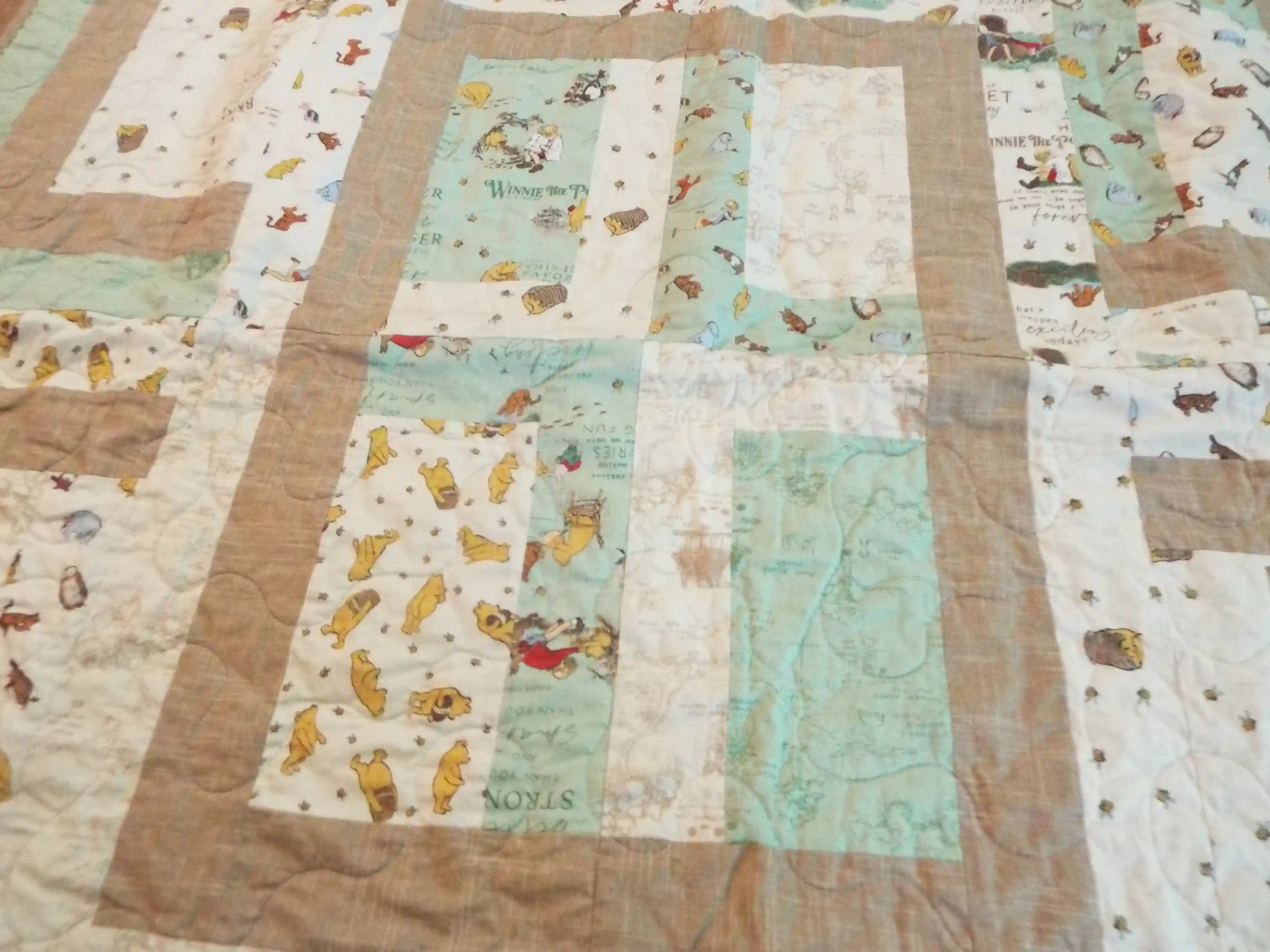 Detail of Stories in the Woods showing close up of fabric and quilt stitching.