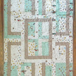 Flat lay of Stories in the Woods Baby Quilt showing entire quilt.
