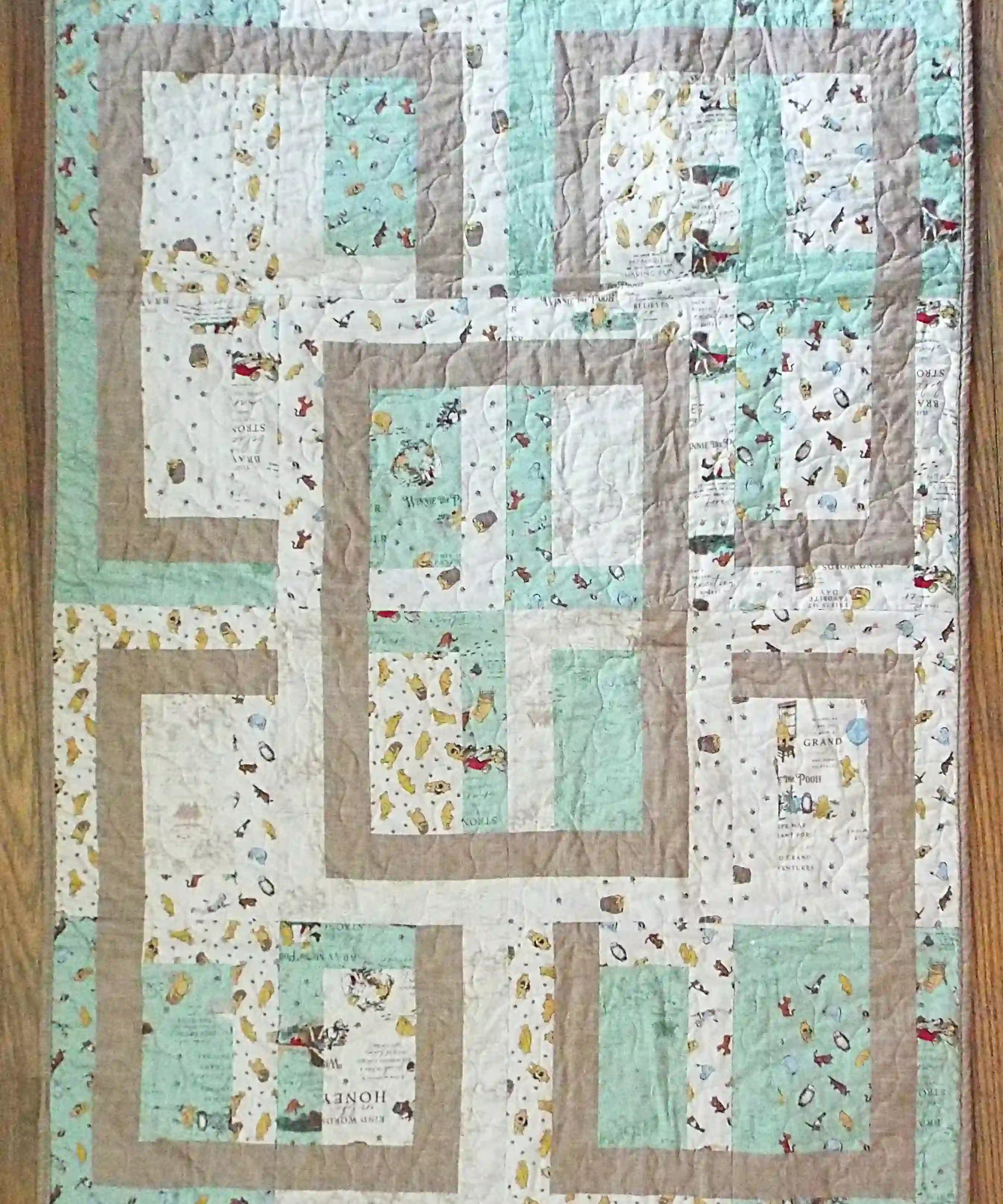 Flat lay of Stories in the Woods Baby Quilt showing entire quilt.