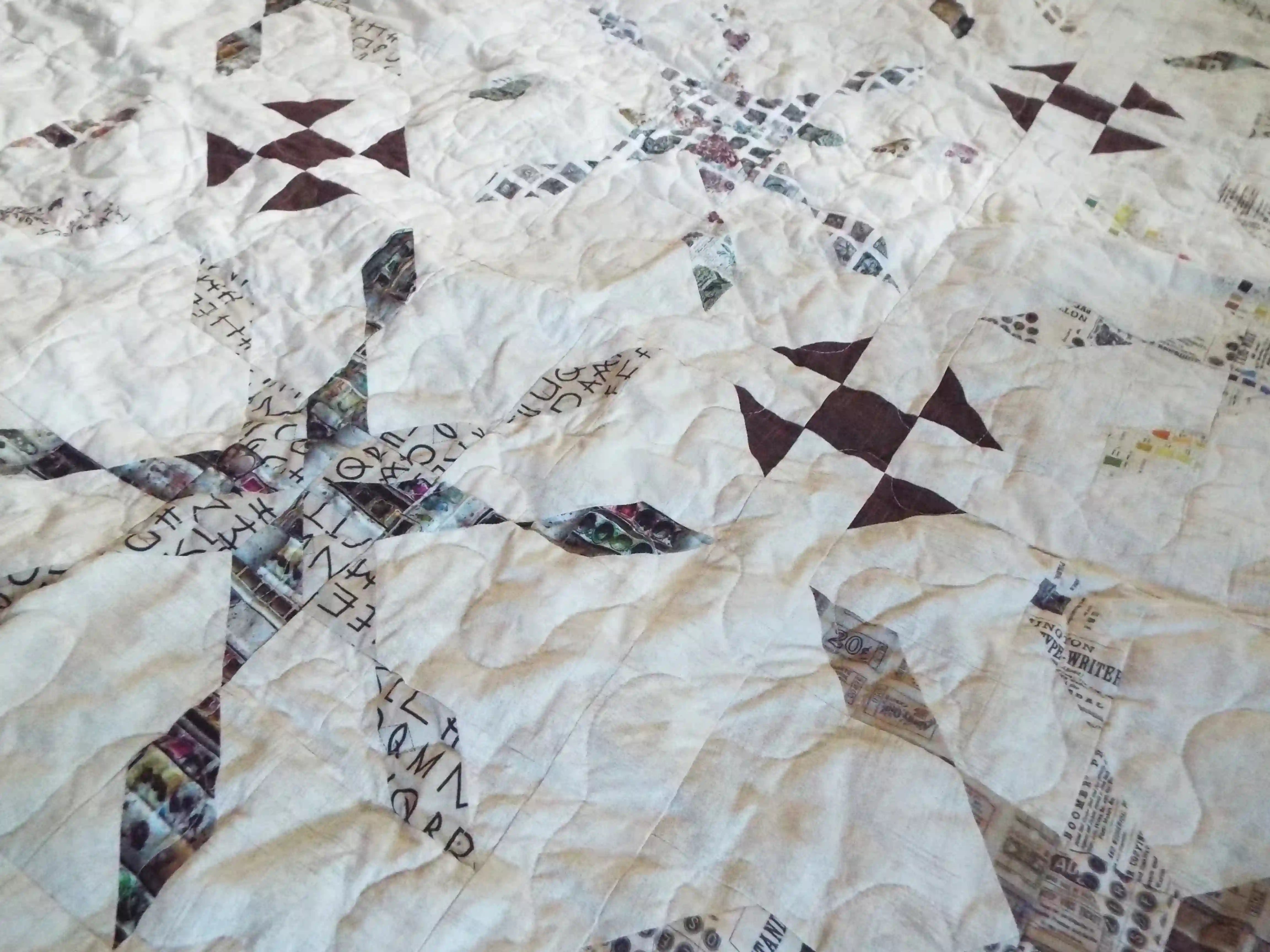 Close up of The Archivist Queen Quilt showing stitching detail and fabric detail.