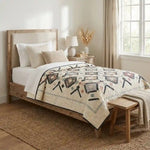 Twin Floral Handmade quilt shown in minimally decorated bedroom with natural materials